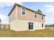 Two-story house with tan siding, backyard, and wooden fence at 1379 E Price Blvd, North Port, FL 34288
