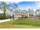 Two-story house with black fence, landscaping, and driveway at 1379 E Price Blvd, North Port, FL 34288