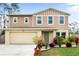 Two-story house with attached garage and landscaping at 1379 E Price Blvd, North Port, FL 34288