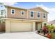 Tan two-story house with attached garage and landscaping at 1379 E Price Blvd, North Port, FL 34288