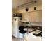 Bright kitchen features white appliances and light wood cabinets at 1519 30Th St, Sarasota, FL 34234