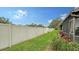 Private backyard with a grassy lawn and vinyl fence at 205 Oak Hill Dr # 7, Sarasota, FL 34232