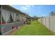 Community backyard with a grassy lawn and vinyl fence at 205 Oak Hill Dr # 7, Sarasota, FL 34232