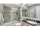 Updated bathroom with a walk-in shower, modern vanity, and tile flooring at 205 Oak Hill Dr # 7, Sarasota, FL 34232