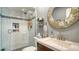 Bathroom with white subway tiles, walk-in shower, and decorative mirror at 205 Oak Hill Dr # 7, Sarasota, FL 34232
