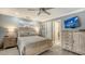 Bedroom with wood furniture, a ceiling fan, and access to the bathroom at 205 Oak Hill Dr # 7, Sarasota, FL 34232