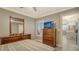 Bedroom with wood dresser, a large TV, and view of the kitchen at 205 Oak Hill Dr # 7, Sarasota, FL 34232