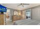 Bedroom with wood furniture, a large TV, and sliding barn doors at 205 Oak Hill Dr # 7, Sarasota, FL 34232
