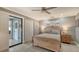 Bedroom with wood-toned furniture, ceiling fan, and access to a private patio at 205 Oak Hill Dr # 7, Sarasota, FL 34232