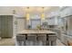 Updated kitchen with gray cabinets, marble countertops, and breakfast bar at 205 Oak Hill Dr # 7, Sarasota, FL 34232