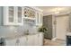 Kitchen wet bar with white cabinets, granite countertop, and wine rack at 205 Oak Hill Dr # 7, Sarasota, FL 34232