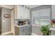 Modern kitchen with gray and white cabinets, granite countertops, and stainless steel appliances at 205 Oak Hill Dr # 7, Sarasota, FL 34232