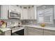 Modern kitchen features stainless steel appliances and white and gray cabinetry at 205 Oak Hill Dr # 7, Sarasota, FL 34232