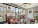 Relaxing screened porch with wicker furniture and a ceiling fan at 205 Oak Hill Dr # 7, Sarasota, FL 34232