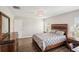 Primary bedroom with wood furniture and gray bedding at 208 Cascade Bend Dr, Ruskin, FL 33570