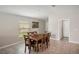 Bright dining room with wood table and chairs, adjacent to the kitchen at 208 Cascade Bend Dr, Ruskin, FL 33570