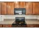 Modern kitchen with black appliances and granite countertops at 208 Cascade Bend Dr, Ruskin, FL 33570