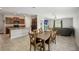 Open concept kitchen with island, dark wood cabinets, and stainless steel appliances at 208 Cascade Bend Dr, Ruskin, FL 33570
