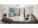 Spacious living room with gray sectional sofa, large TV, and sliding glass doors leading to backyard at 208 Cascade Bend Dr, Ruskin, FL 33570
