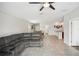 Open-concept living area with gray sectional sofa and views into kitchen and dining area at 208 Cascade Bend Dr, Ruskin, FL 33570