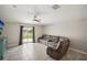 Living room features a comfortable gray sectional sofa and access to a patio through sliding doors at 208 Cascade Bend Dr, Ruskin, FL 33570