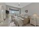 Bright bedroom featuring a comfy bed and window seating area at 230 Vestavia Dr, Venice, FL 34292