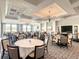 Bright and airy clubhouse dining area with large windows and chandeliers at 230 Vestavia Dr, Venice, FL 34292