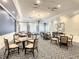 Casual dining area in clubhouse with smaller tables and chairs at 230 Vestavia Dr, Venice, FL 34292