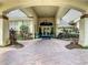Inviting clubhouse entrance with landscaping and a brick walkway at 230 Vestavia Dr, Venice, FL 34292