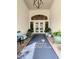 Elegant clubhouse entrance with a blue rug and potted plants at 230 Vestavia Dr, Venice, FL 34292