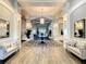 Spacious clubhouse lobby with comfortable seating and large mirrors at 230 Vestavia Dr, Venice, FL 34292