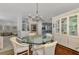 Open dining room with a glass-top table and views into other rooms at 230 Vestavia Dr, Venice, FL 34292
