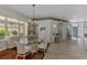 Spacious dining room, featuring a glass-top table and an abundance of natural light at 230 Vestavia Dr, Venice, FL 34292