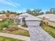 Single-story home with gray tile roof, white garage door, and landscaped yard at 230 Vestavia Dr, Venice, FL 34292