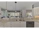 Kitchen with double sink, granite counters, and white cabinets at 230 Vestavia Dr, Venice, FL 34292