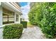 Landscaped backyard with gravel pathway and lush greenery at 2325 Riverbluff Pkwy # V247, Sarasota, FL 34231
