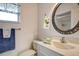 Clean bathroom with white vanity and an ornate mirror at 2325 Riverbluff Pkwy # V247, Sarasota, FL 34231