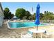 Inviting community pool with ample lounge chairs and patio tables at 2325 Riverbluff Pkwy # V247, Sarasota, FL 34231