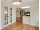 Dining room with wood flooring and French doors at 2325 Riverbluff Pkwy # V247, Sarasota, FL 34231