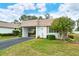 Front view of white single-story home with carport at 2325 Riverbluff Pkwy # V247, Sarasota, FL 34231