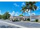 Community building exterior with parking and landscaping at 2325 Riverbluff Pkwy # V247, Sarasota, FL 34231