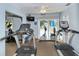 Bright fitness center featuring treadmills, stationary bikes, and a TV at 2325 Riverbluff Pkwy # V247, Sarasota, FL 34231