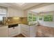 Eat-in kitchen with granite countertops and access to a sunroom at 2325 Riverbluff Pkwy # V247, Sarasota, FL 34231