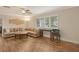 Living room with sectional sofa and wood floors at 2325 Riverbluff Pkwy # V247, Sarasota, FL 34231