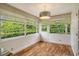 Sunroom with wood flooring and plenty of natural light at 2325 Riverbluff Pkwy # V247, Sarasota, FL 34231