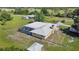 Aerial view of a home, pool, and expansive property with outbuildings at 33931 Serene Dr, Punta Gorda, FL 33982