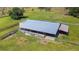 Aerial view of a long covered animal shelter with attached smaller shed at 33931 Serene Dr, Punta Gorda, FL 33982