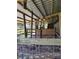 Interior of a rustic animal shelter with wooden stalls at 33931 Serene Dr, Punta Gorda, FL 33982
