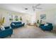 Bright living room featuring teal sofas and entryway at 33931 Serene Dr, Punta Gorda, FL 33982