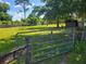 Open pasture with a gate and grassy area at 33931 Serene Dr, Punta Gorda, FL 33982